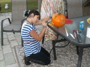 Gracie carving pumpkins