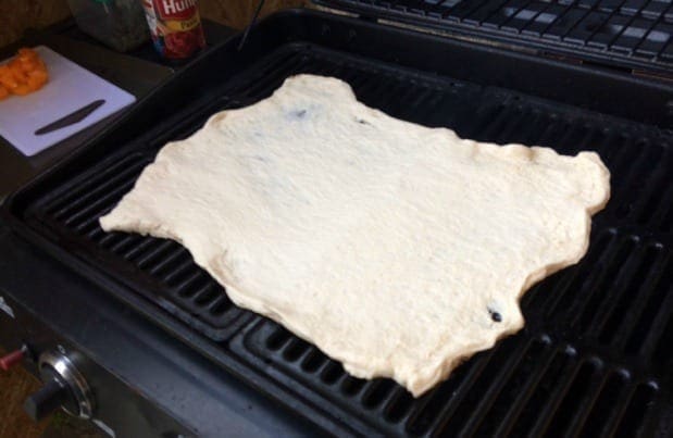 Pizza dough unrolled on grill Grilled Pizza